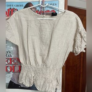 Tan and white striped blouse. Buttons on the back. Scrunched at the bottom